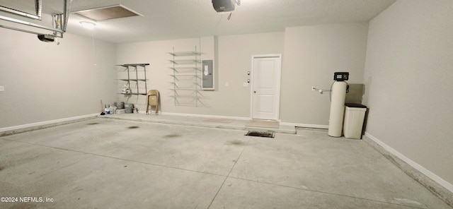 garage featuring electric panel and a garage door opener