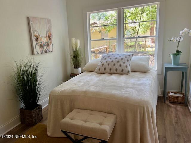 bedroom with wood-type flooring