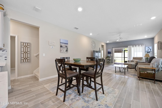 dining area with ceiling fan and light hardwood / wood-style flooring