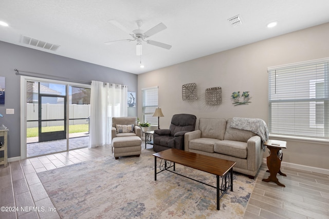 living room featuring ceiling fan and light hardwood / wood-style flooring