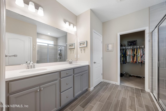 bathroom featuring vanity and an enclosed shower