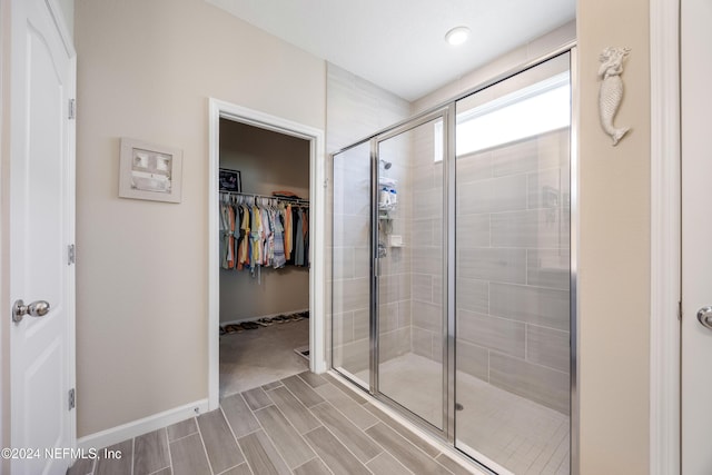 bathroom with a shower with door