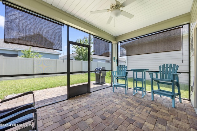 sunroom / solarium with ceiling fan and wooden ceiling