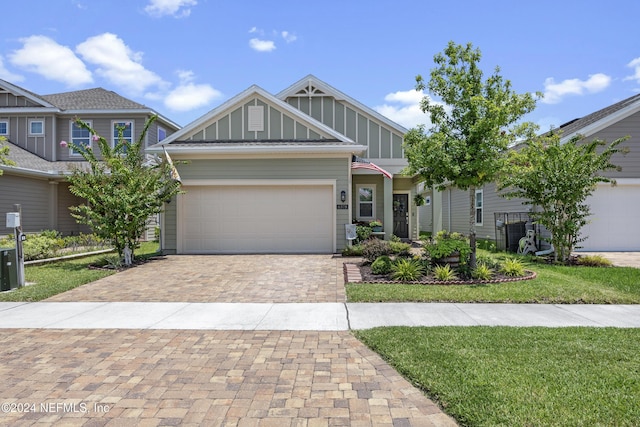 view of front of property with a front yard and a garage