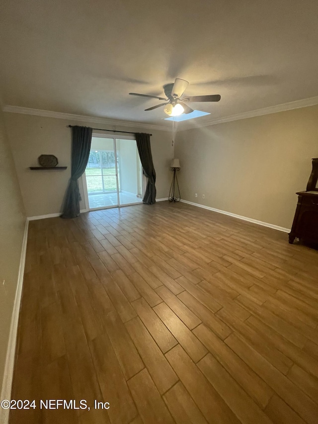 empty room with ceiling fan, light hardwood / wood-style floors, and ornamental molding