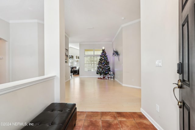 entryway with hardwood / wood-style floors and ornamental molding