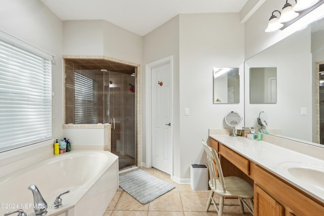 bathroom with tile patterned floors, vanity, and shower with separate bathtub