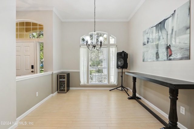 entrance foyer featuring a chandelier, a healthy amount of sunlight, and light hardwood / wood-style flooring