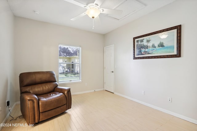 living area featuring ceiling fan and light hardwood / wood-style flooring