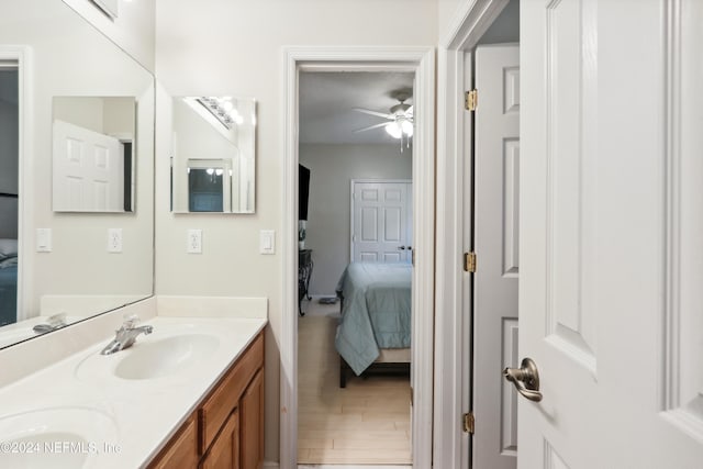 bathroom with vanity, ceiling fan, and wood-type flooring