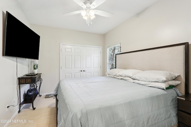 bedroom featuring ceiling fan, a closet, and light wood-type flooring