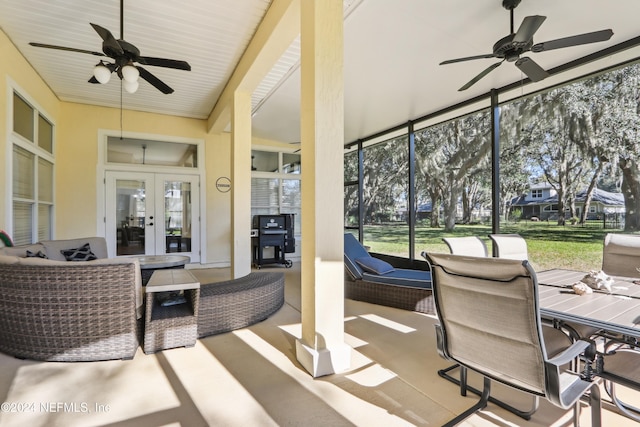 sunroom with ceiling fan and french doors