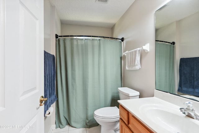 bathroom with tile patterned floors, vanity, toilet, and a textured ceiling