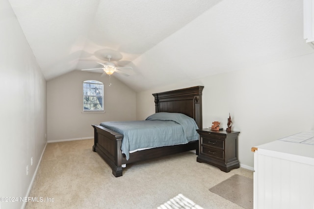 carpeted bedroom featuring ceiling fan and vaulted ceiling