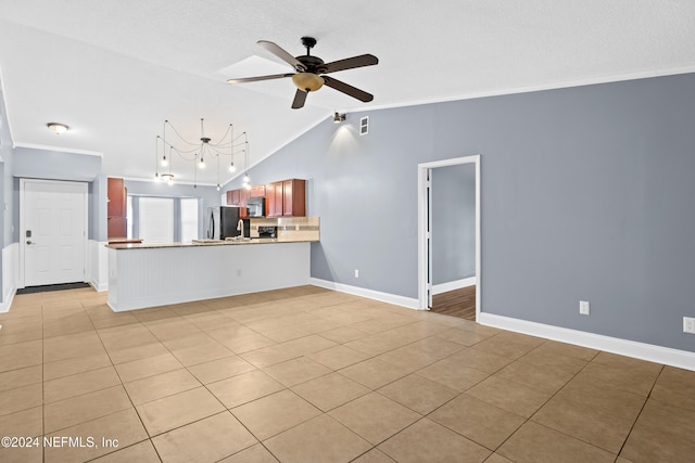 unfurnished living room with vaulted ceiling, ceiling fan, ornamental molding, and light tile patterned flooring