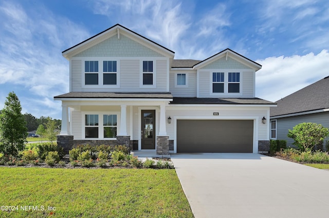 view of front facade featuring a garage and a front lawn