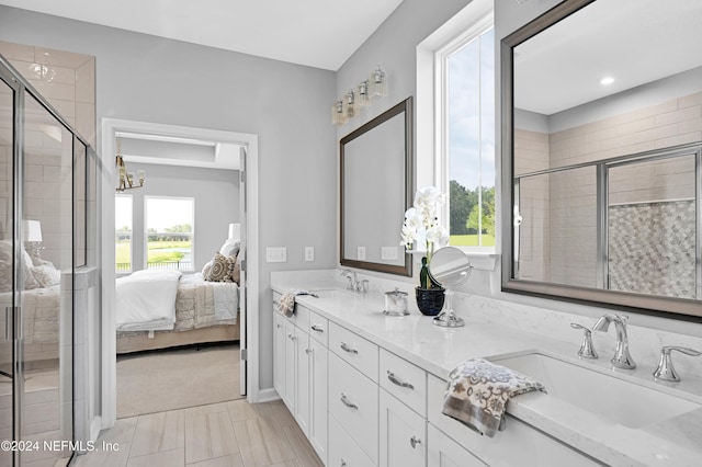 bathroom with tile patterned flooring, vanity, and a shower with shower door