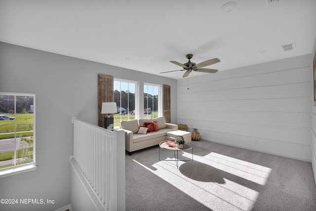 living room featuring ceiling fan and carpet floors