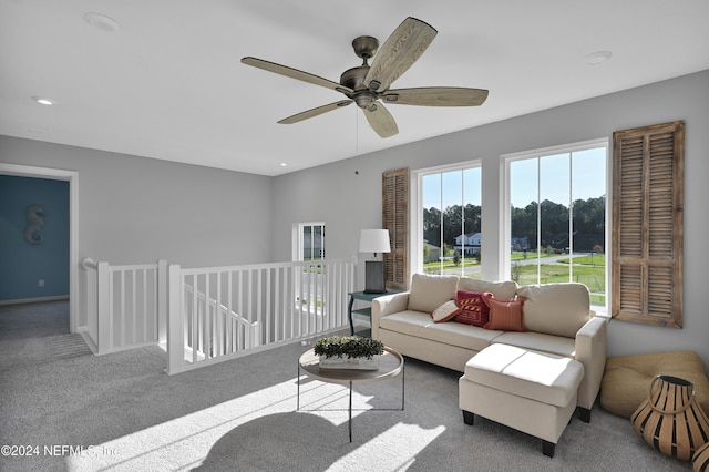 carpeted living room featuring ceiling fan