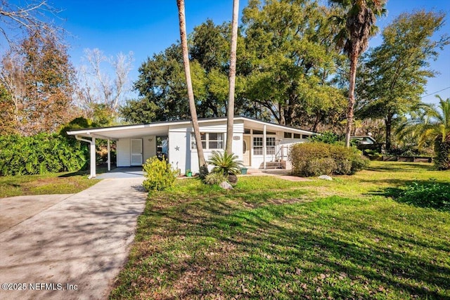 ranch-style home with a carport and a front yard