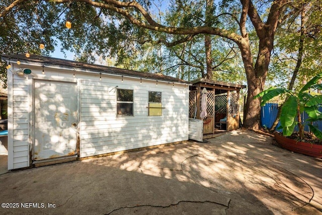 view of side of property with a patio