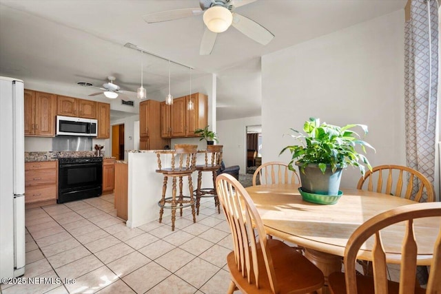 dining room featuring ceiling fan and light tile patterned floors