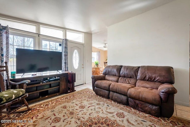 tiled living room with ceiling fan