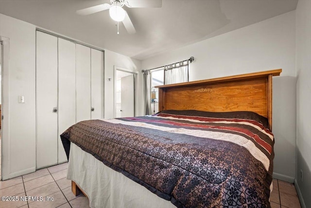 bedroom featuring ceiling fan, light tile patterned floors, and a closet