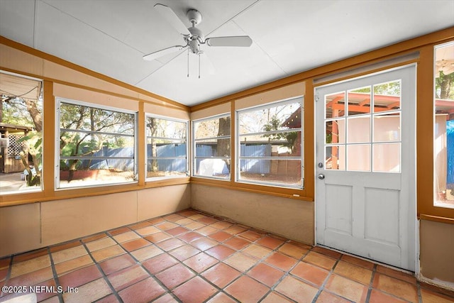 unfurnished sunroom with ceiling fan and vaulted ceiling