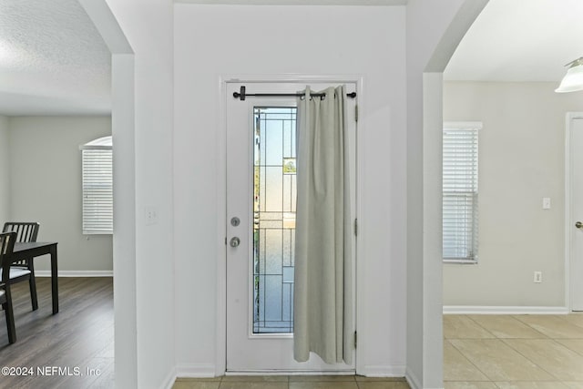 entryway featuring a textured ceiling and light wood-type flooring