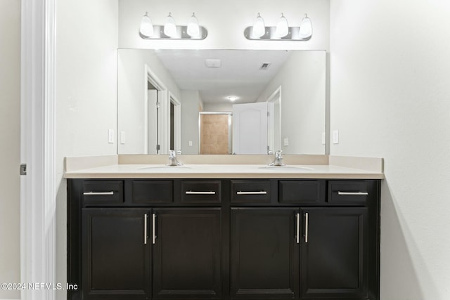 bathroom with vanity and a shower with shower door