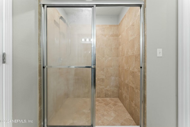 bathroom with a shower with door