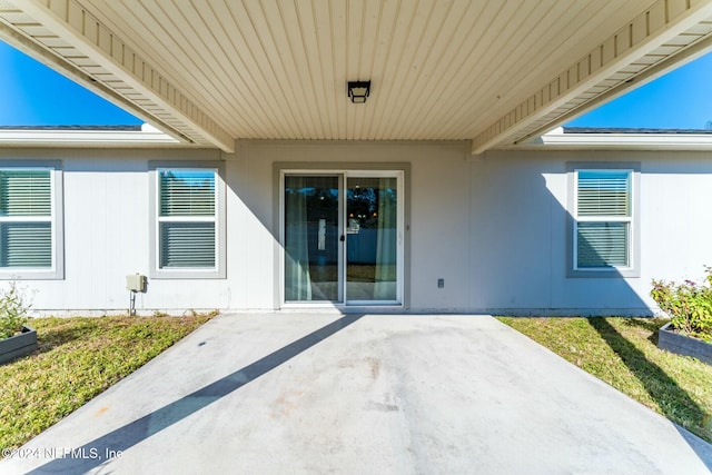 entrance to property featuring a patio