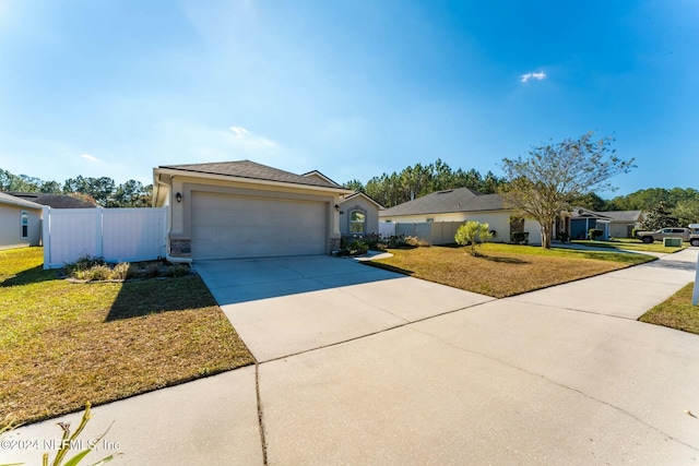 ranch-style house featuring a front yard and a garage