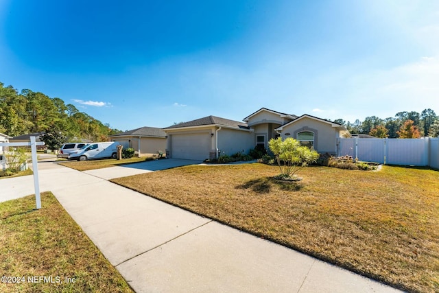 single story home featuring a garage and a front lawn