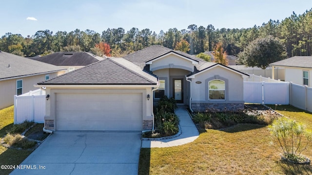 view of front facade with a garage and a front lawn