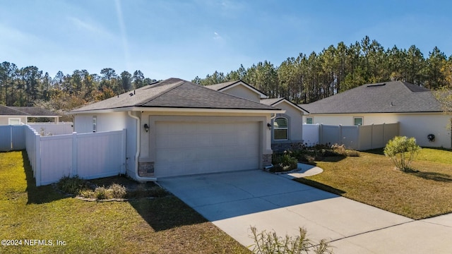 single story home featuring a garage and a front lawn