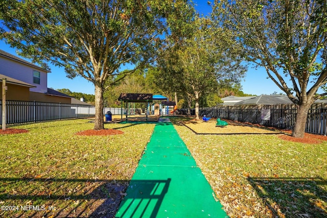 view of property's community with a lawn