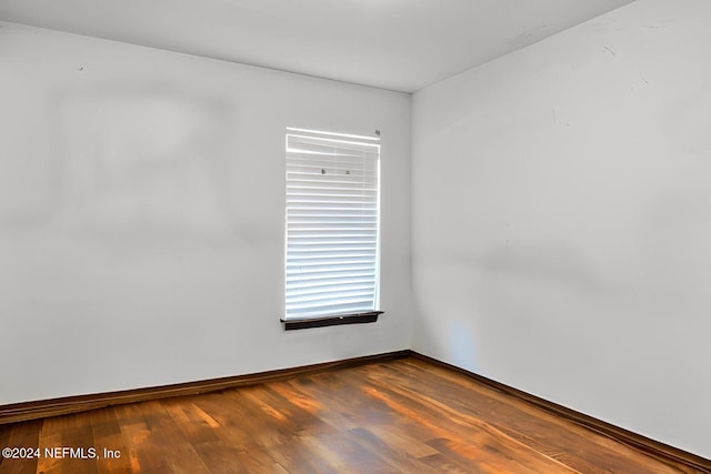 spare room with wood-type flooring