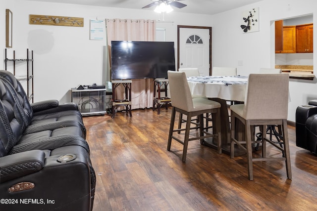 dining space with ceiling fan and dark hardwood / wood-style flooring