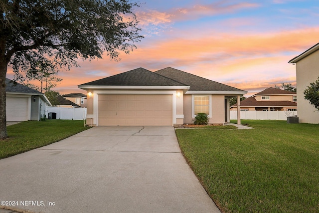 view of front facade featuring a lawn and a garage