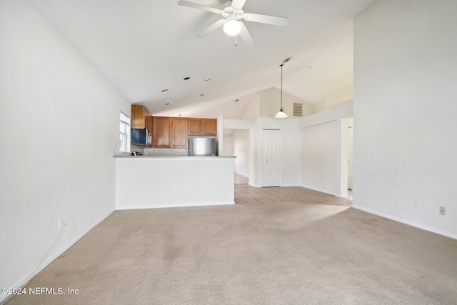 unfurnished living room with ceiling fan, light carpet, and high vaulted ceiling