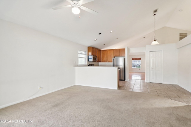 unfurnished living room with light carpet, vaulted ceiling, and ceiling fan