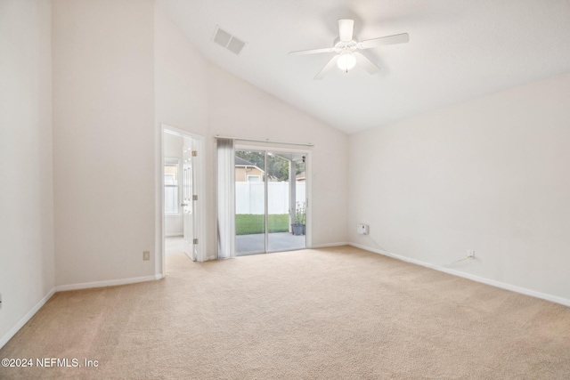 spare room featuring ceiling fan, light colored carpet, and high vaulted ceiling