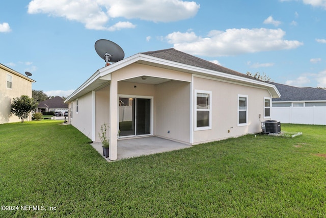 back of property featuring a lawn, a patio area, and central air condition unit