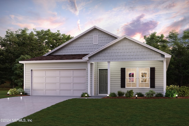 view of front of property with a lawn and a garage