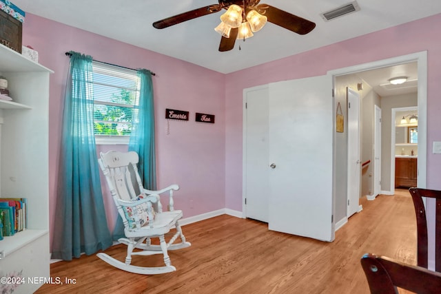 living area with ceiling fan and light wood-type flooring