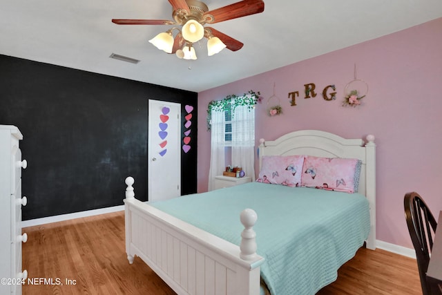 bedroom featuring light hardwood / wood-style floors and ceiling fan