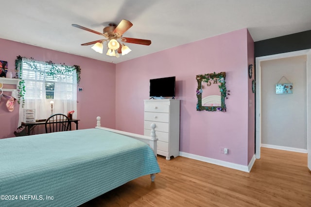 bedroom with ceiling fan and light hardwood / wood-style floors