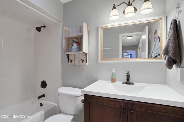 full bathroom featuring vanity, tiled shower / bath, and toilet